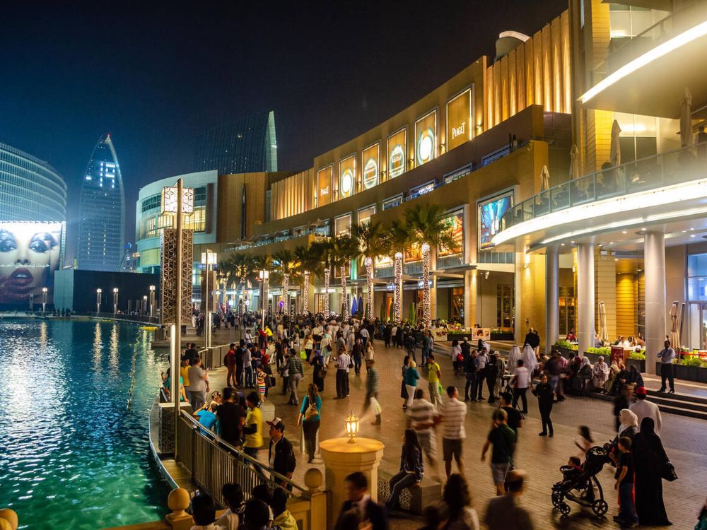 shoppers walking outside the dubai mall during dsf sale in december